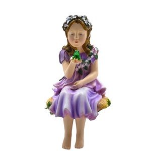 Fairy with Purple Flowers Sitting holding a Frog Figurine